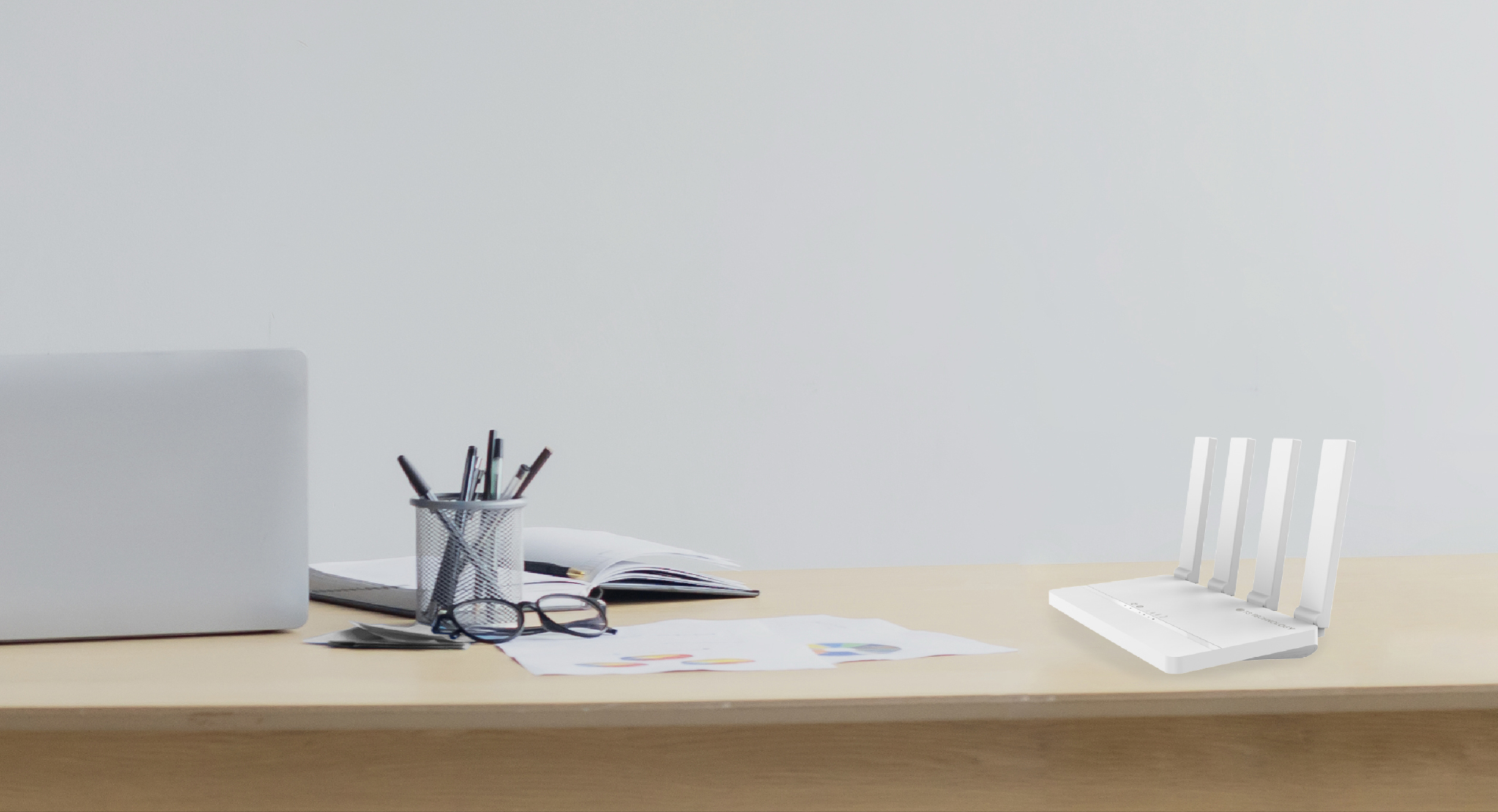 C21 router beside a laptop on an office desk