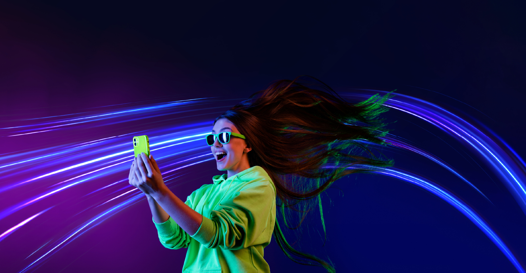 Woman using a phone, surrounded by colourful light trails