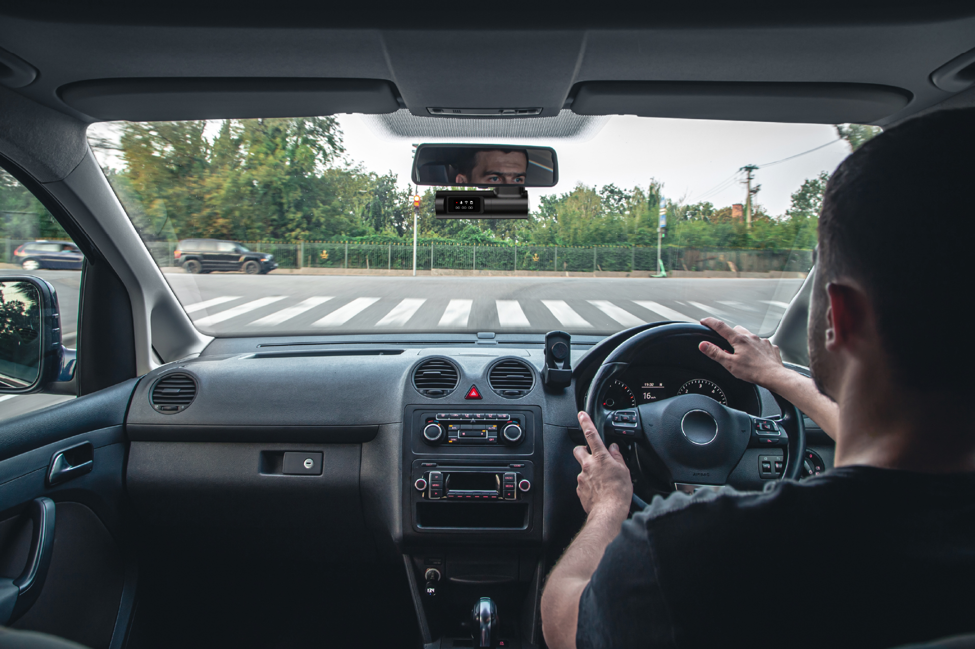 Front dash camera installed behind a rear view mirror