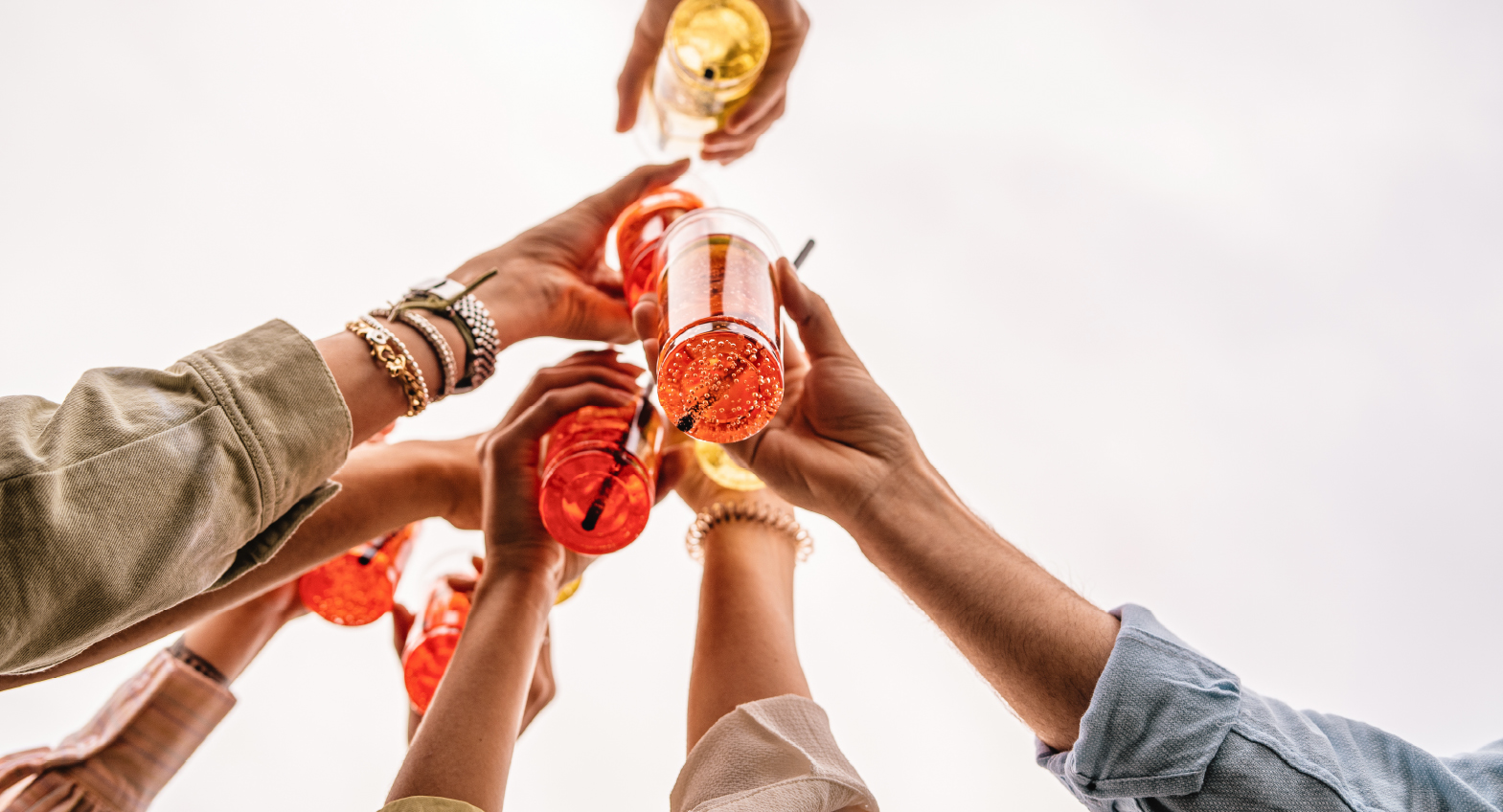 Friends toasting with colourful drinks
